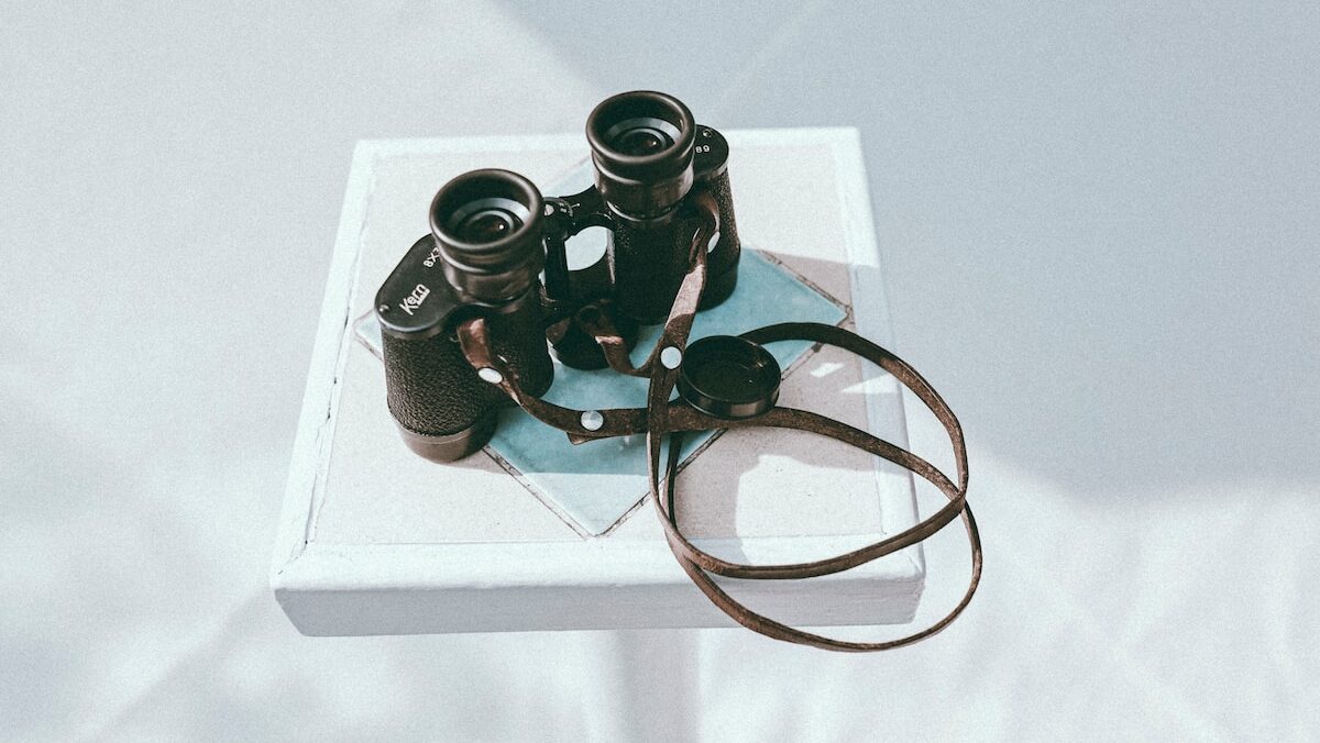 A pair of binoculars sitting on a white table.